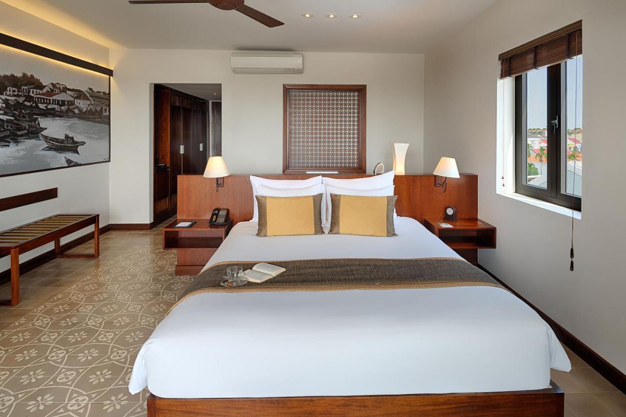 Rivertown Hoi An Resort & Spa Bagian luar foto A bedroom at the hotel